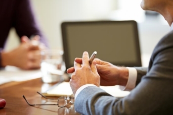 Financial Avisors hands on a conference table